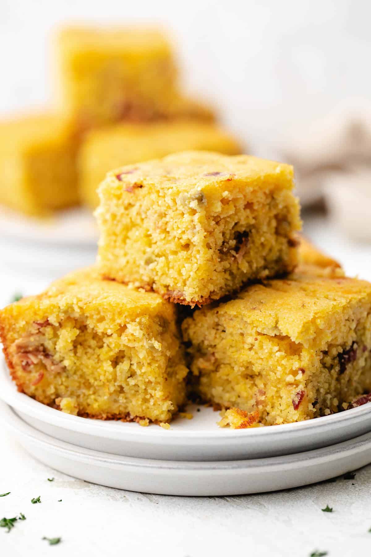 Pile of cornbread on plates.