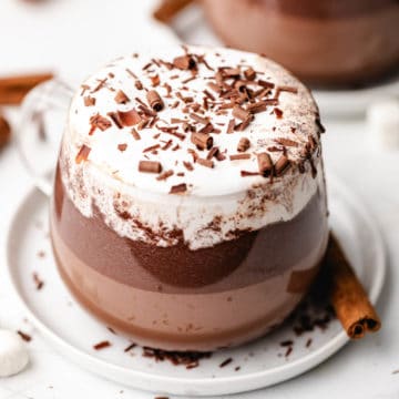 Mexican hot chocolate in a glass mug.