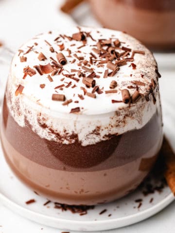 Mexican hot chocolate in a glass mug.