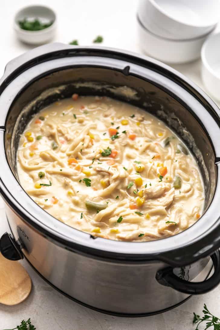 Chicken with egg noodles and vegetables in a crock pot.