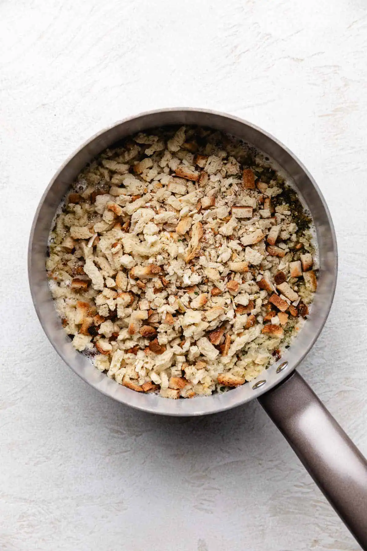 Stuffing mix poured into a pan with broth and butter.