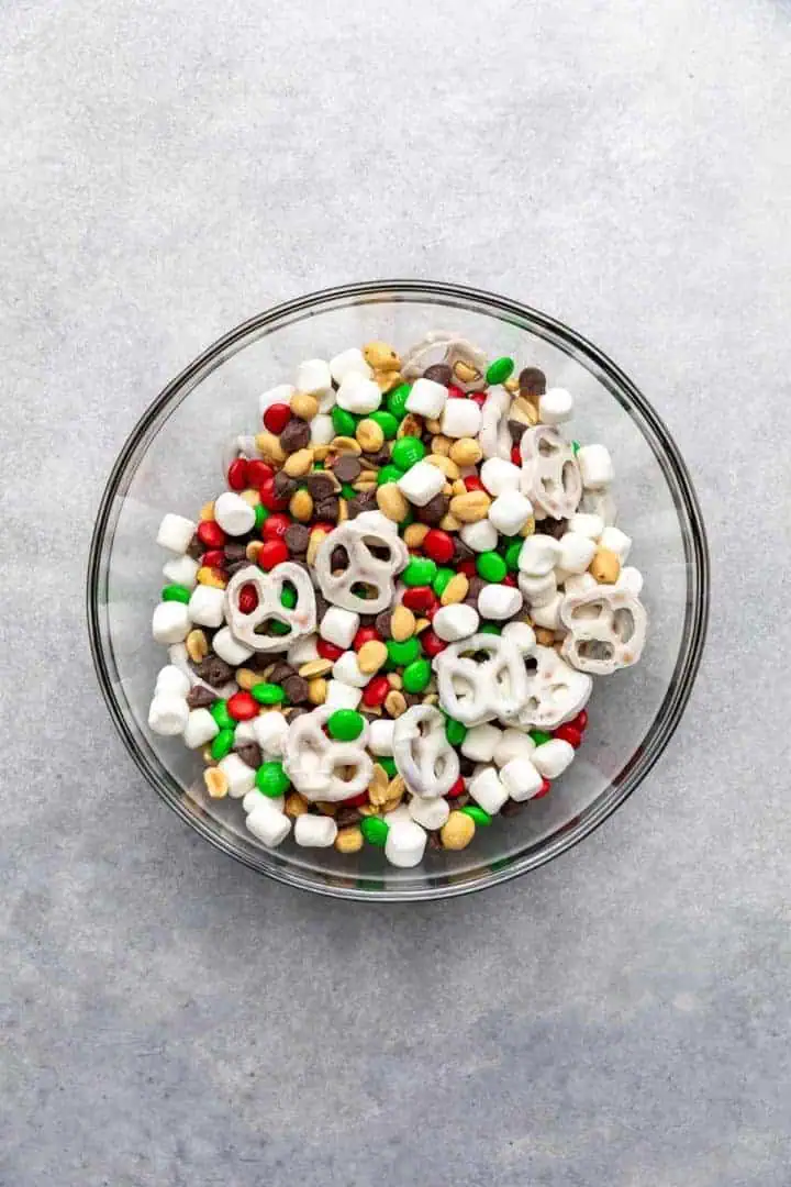 Top down view of snack mix in a glass bowl.