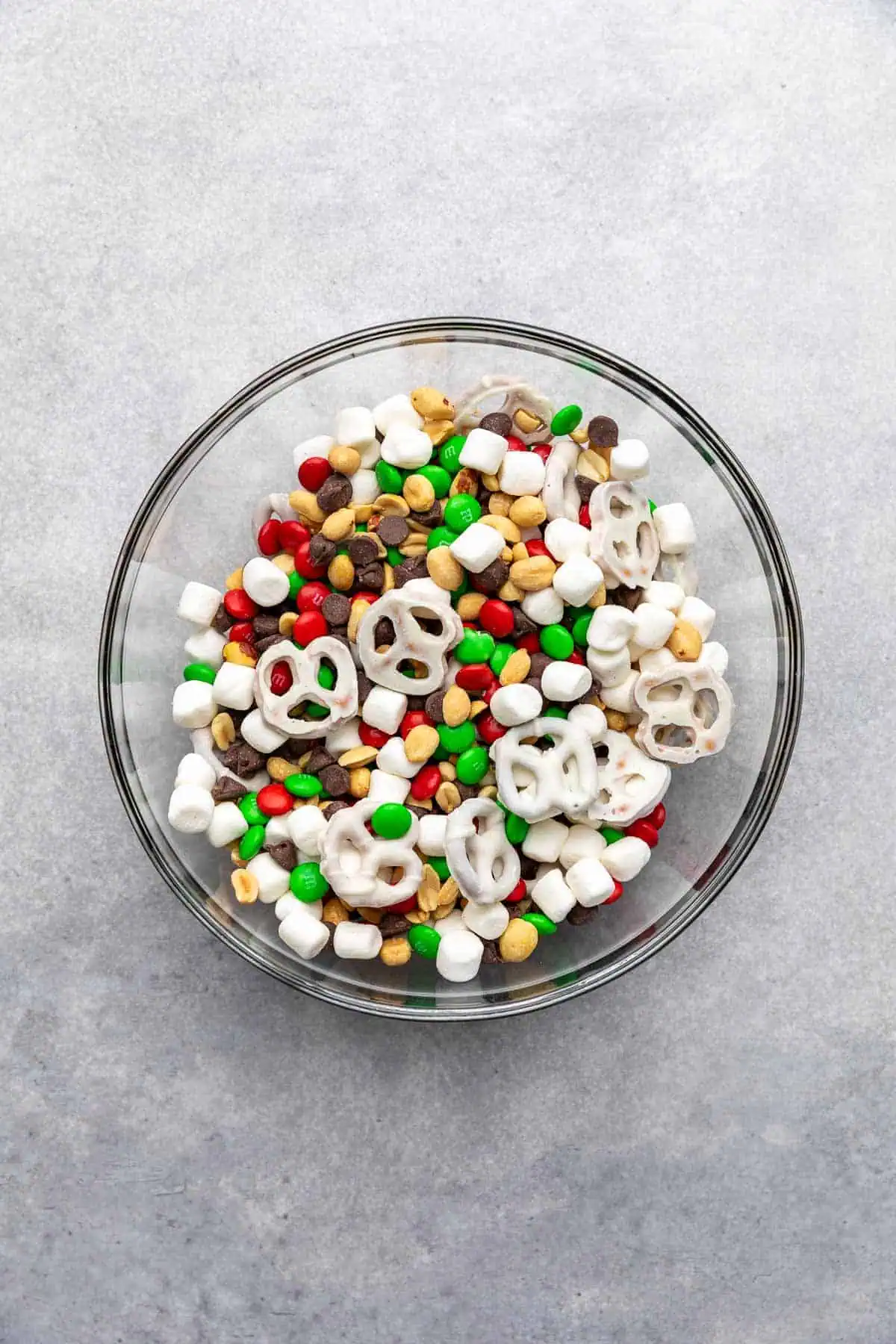 Top down view of snack mix in a glass bowl.