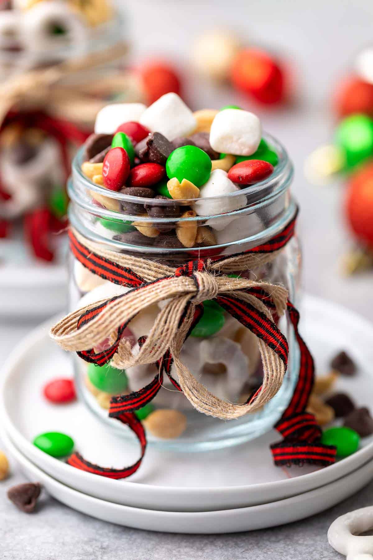 Close up view of a jar of snack mix with ribbons.