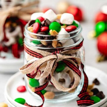 Close up view of a jar of candy and nuts.