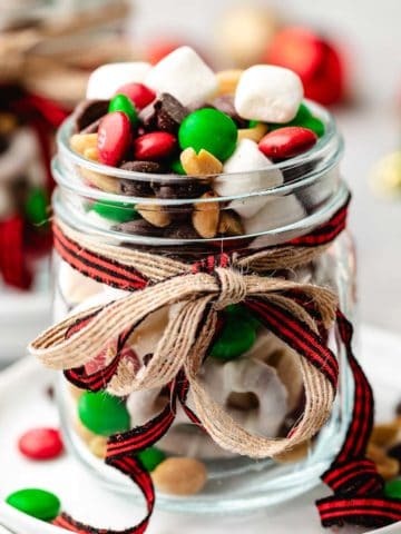 Close up view of a jar of candy and nuts.