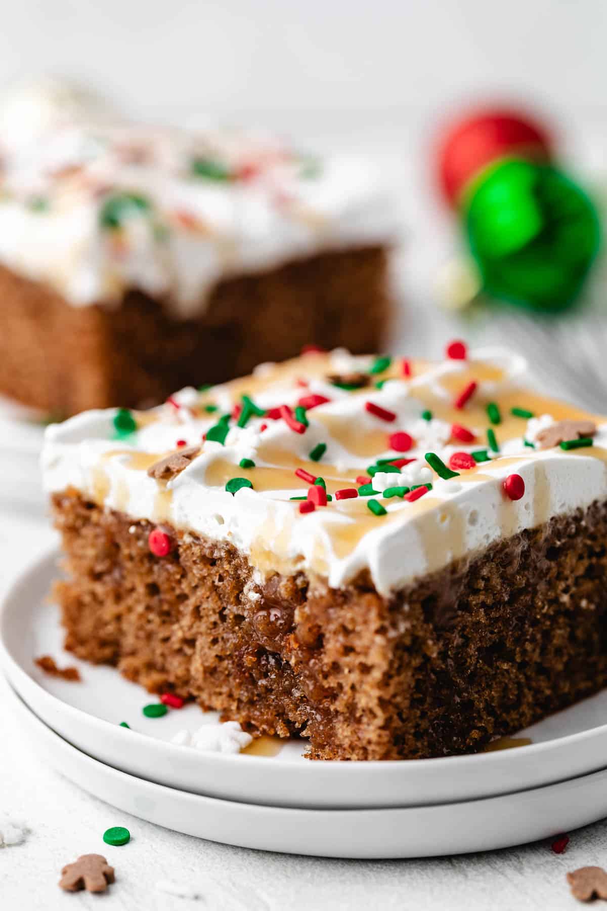 Christmas sprinkles on a cake with whipped topping.