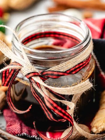 Close up view of ribbons tied around a jar of simple syrup.