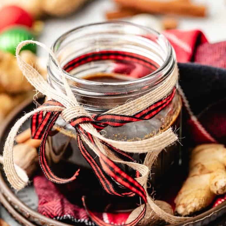 Close up view of ribbons tied around a jar of simple syrup.