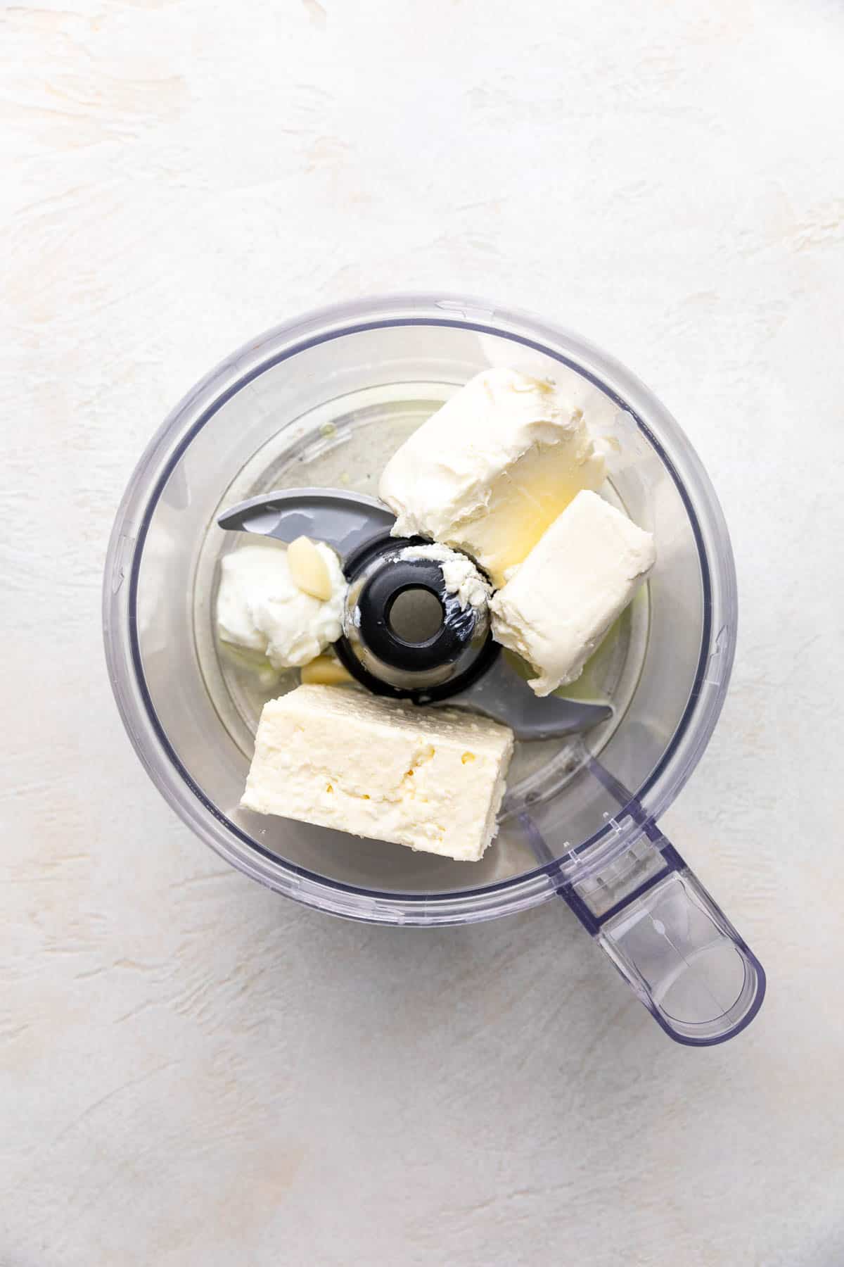 Cream cheese, feta, garlic, pepperoncini juice in a food processor.