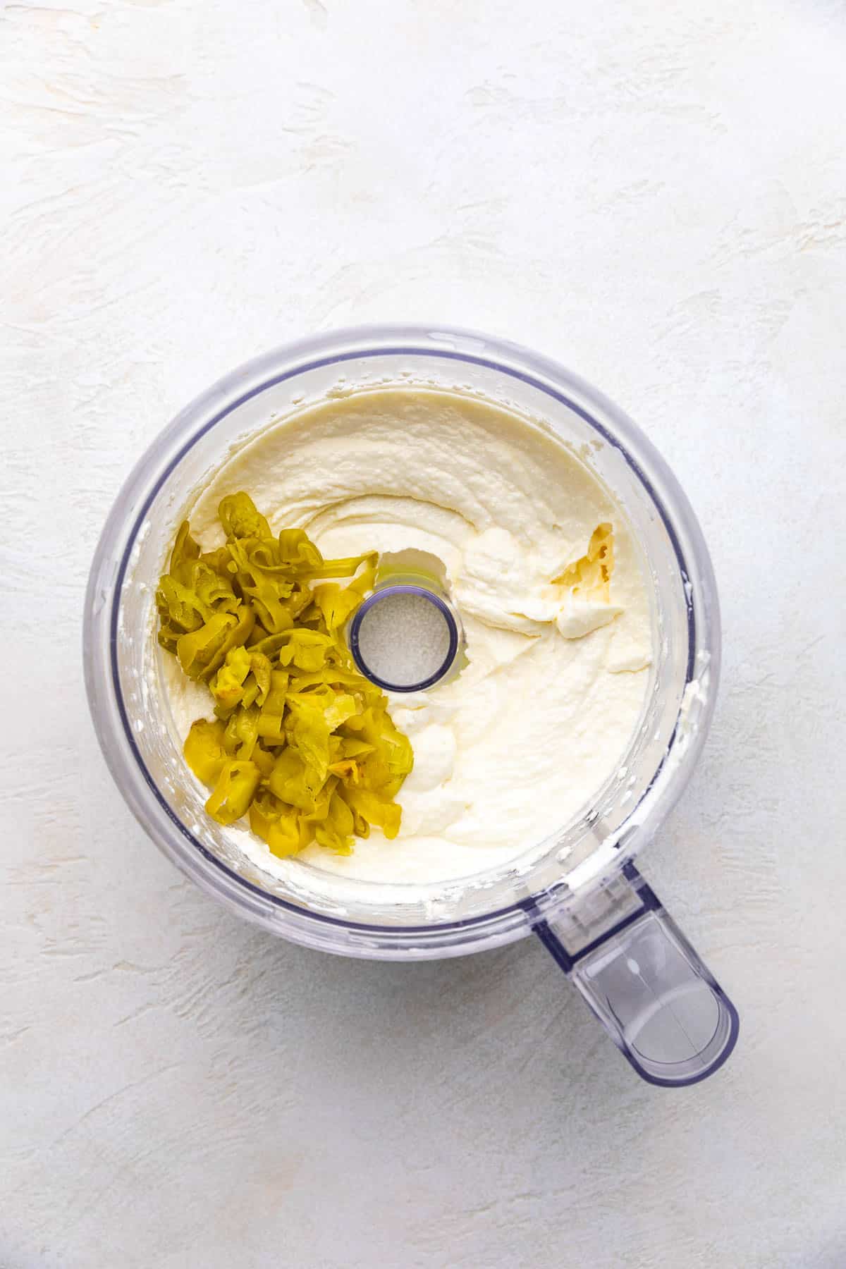 Pepperoncini and feta dip added to a food processor.