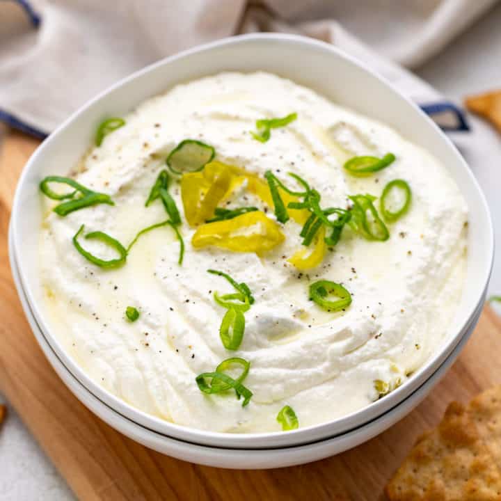 Feta dip with pepperoncini in a bowl.