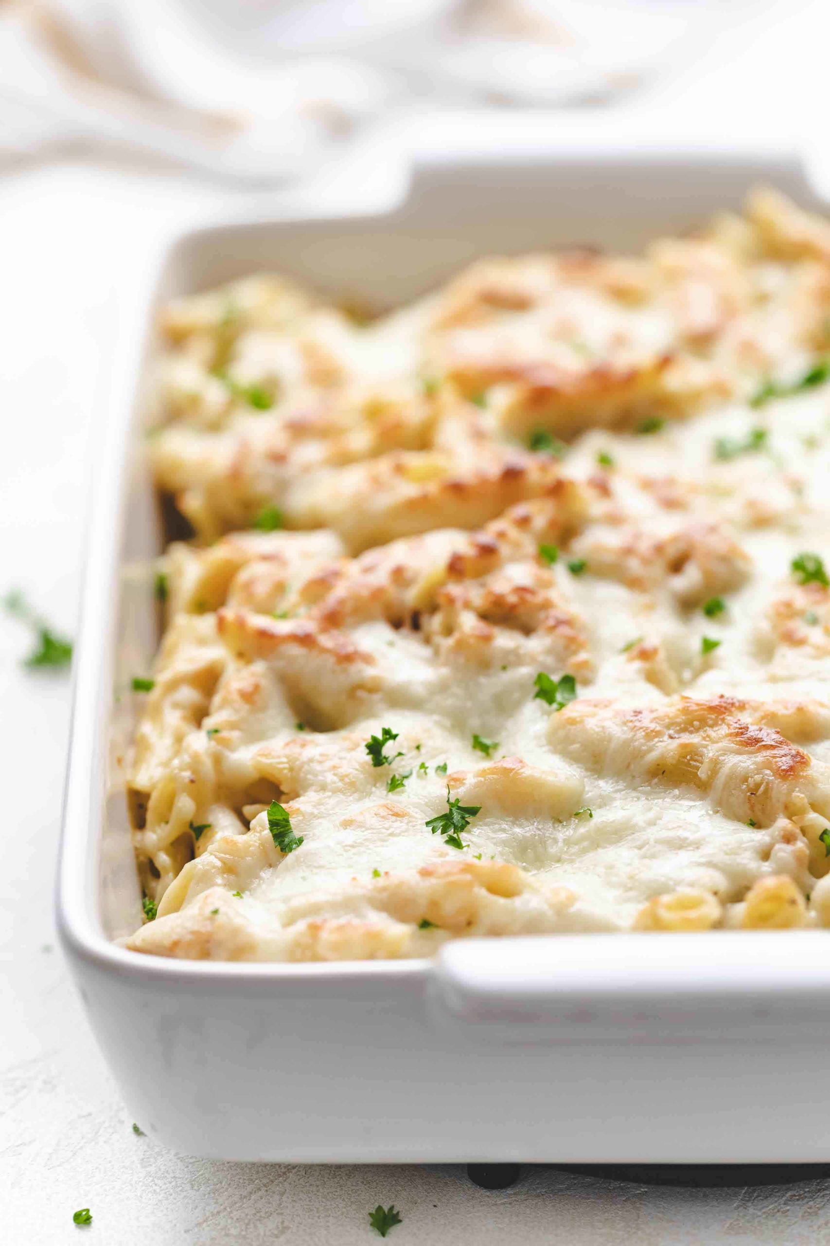 Side view of cheesy chicken pasta bake in a pan.