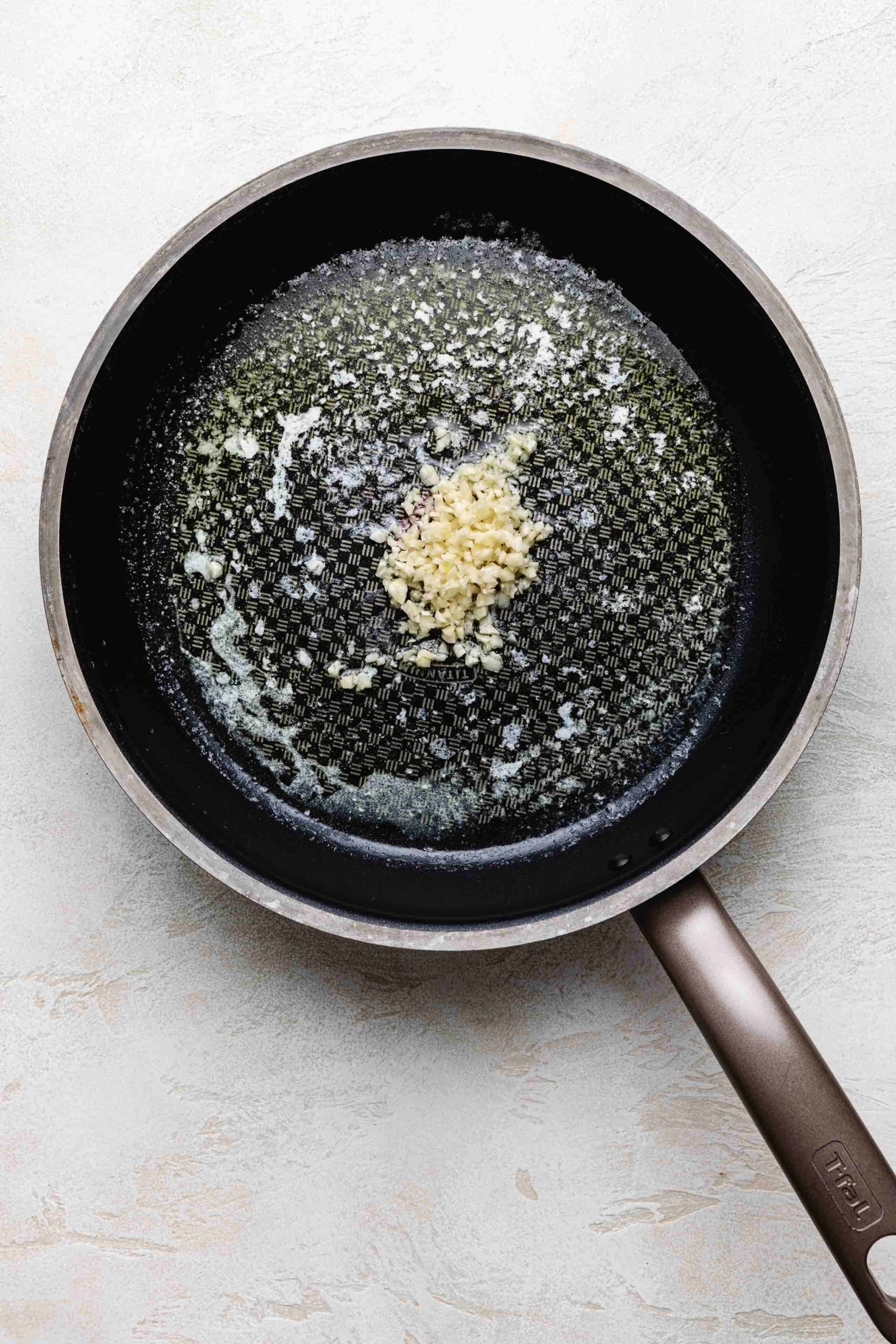 Minced garlic and butter in a pan.