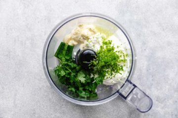 Ingredients for lime crema in a food processor.