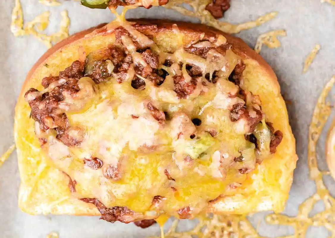 Texas toast covered with sloppy joes and cheese.