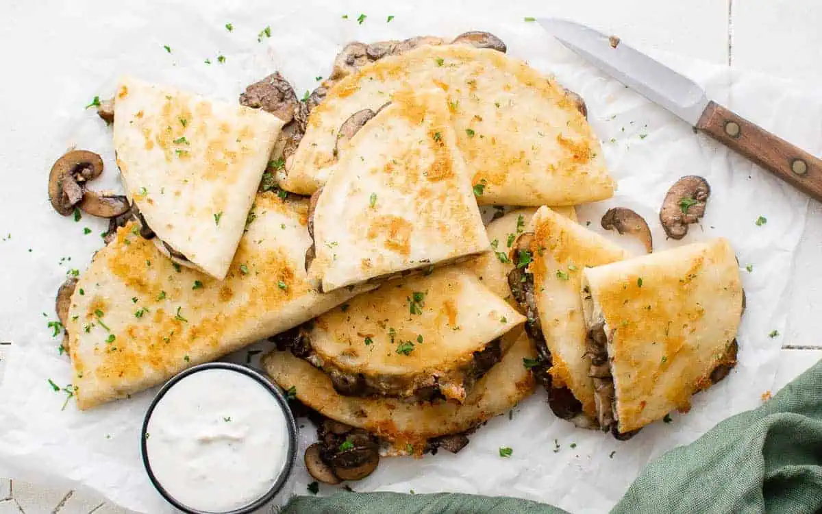 Mushroom quesadillas with sour cream.