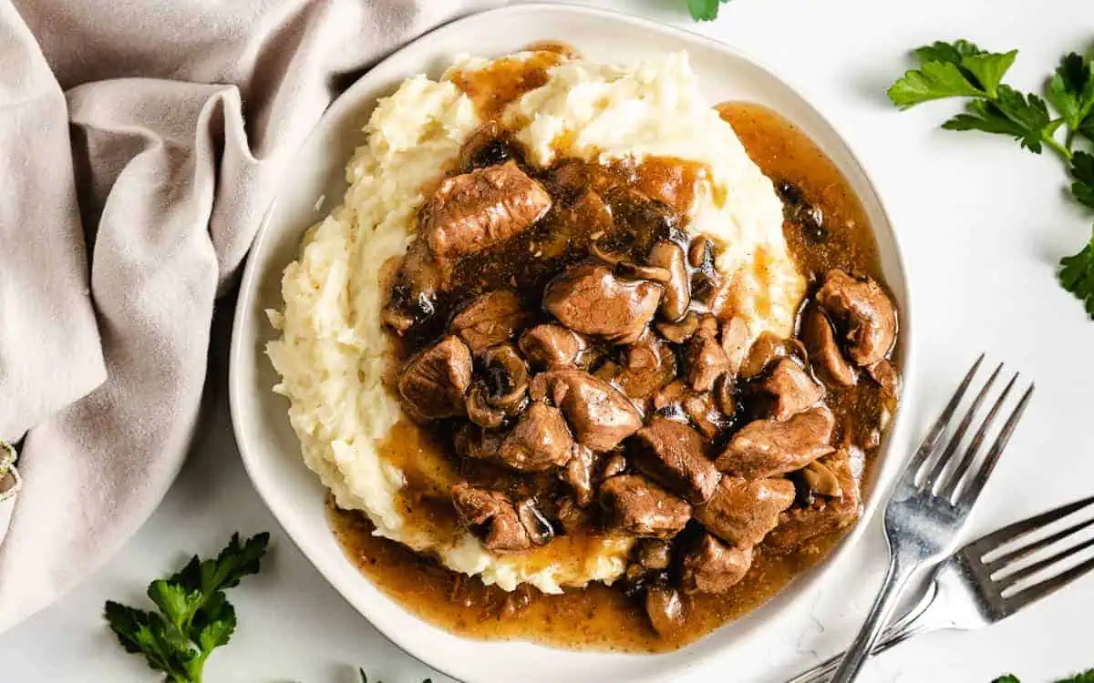 Beef tips and gravy on potatoes.