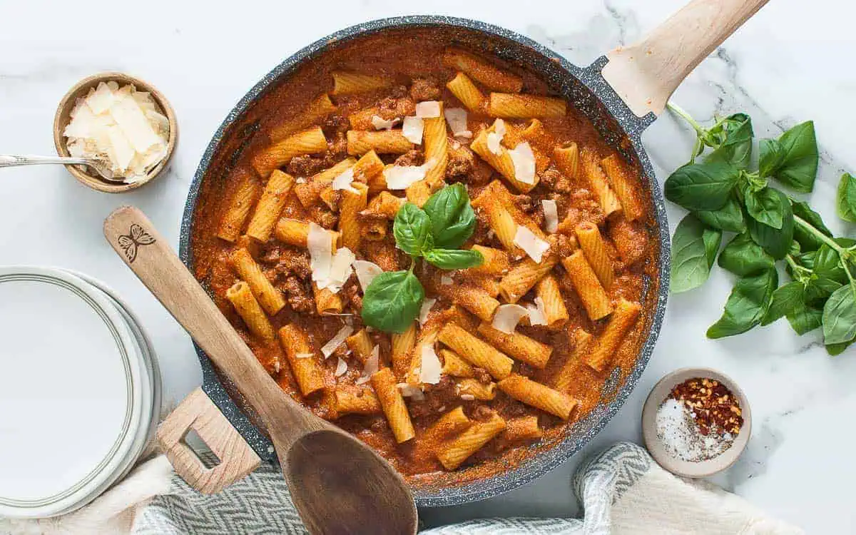 Pan of pasta with meat and cottage cheese sauce.