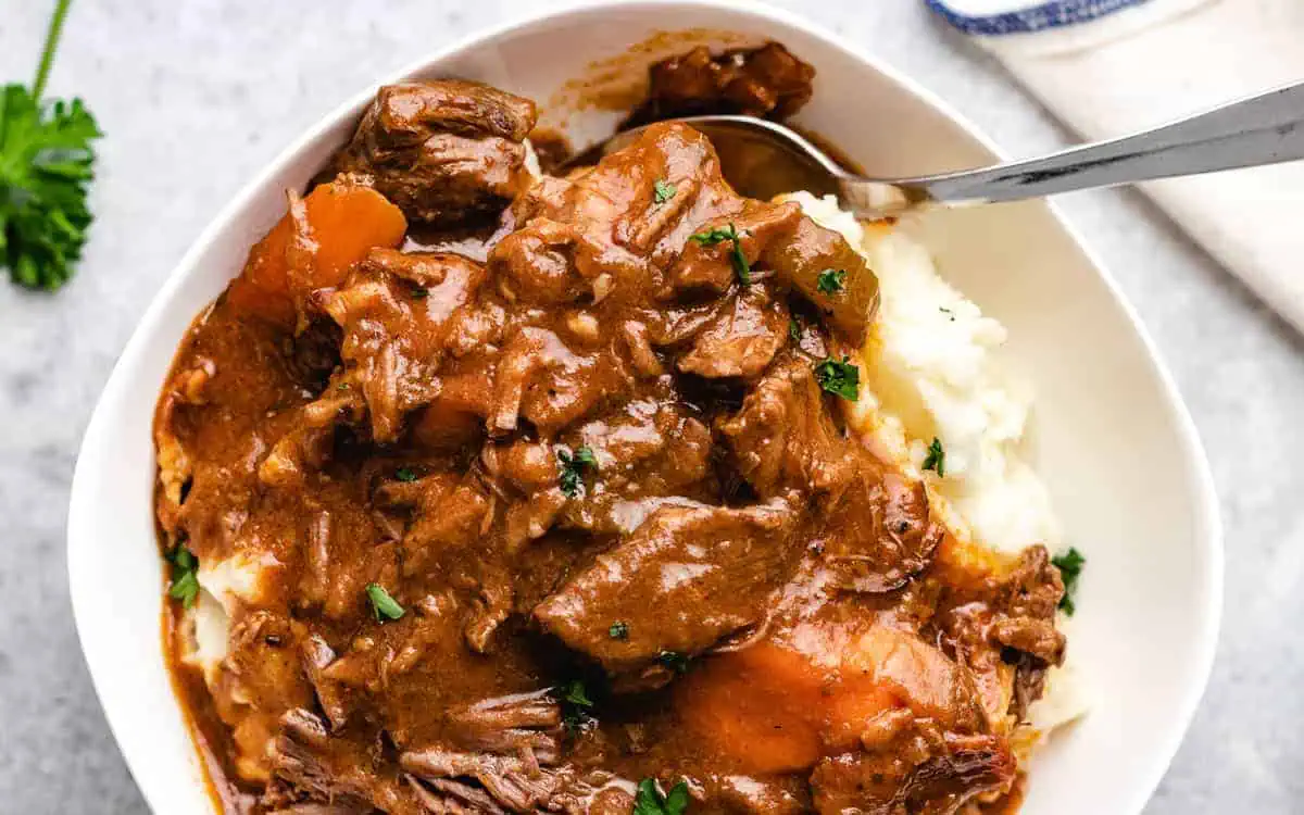 Irish beef stew on top of potatoes.