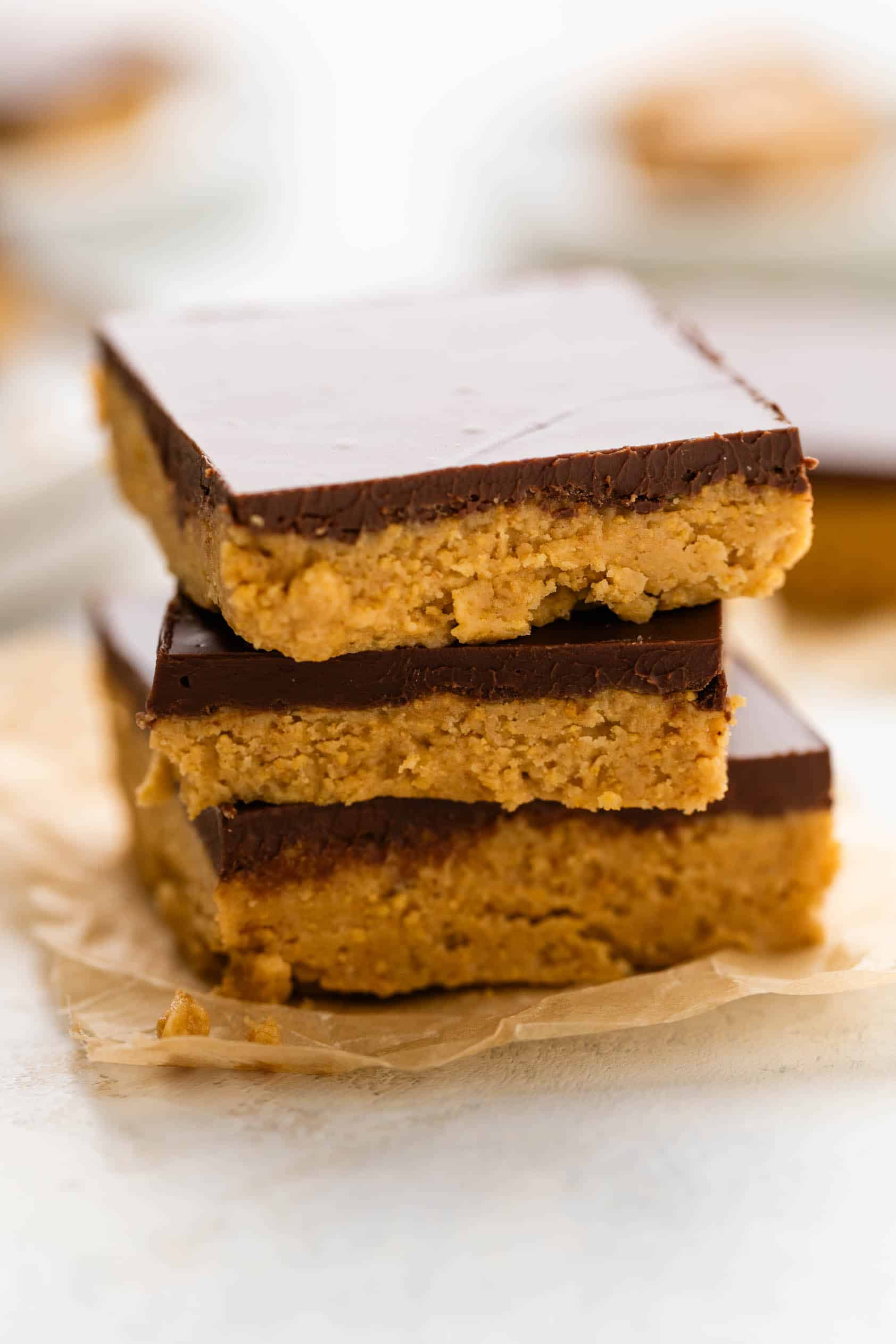 Peanut butter bars topped with chocolate.