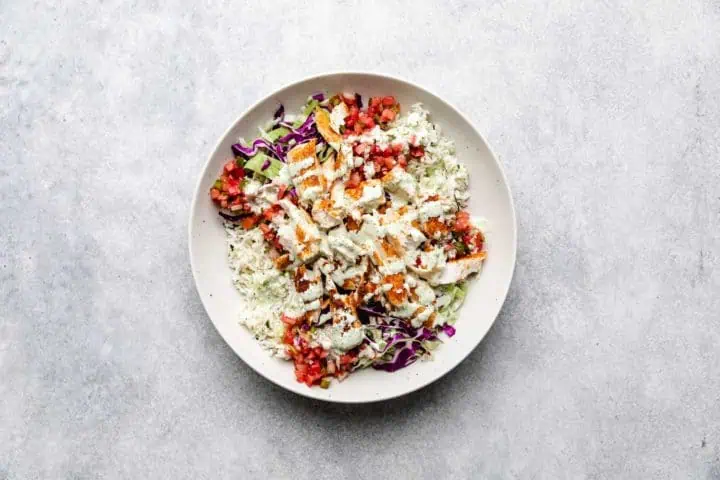 Crema drizzled over fish, rice, cabbage, and pico.