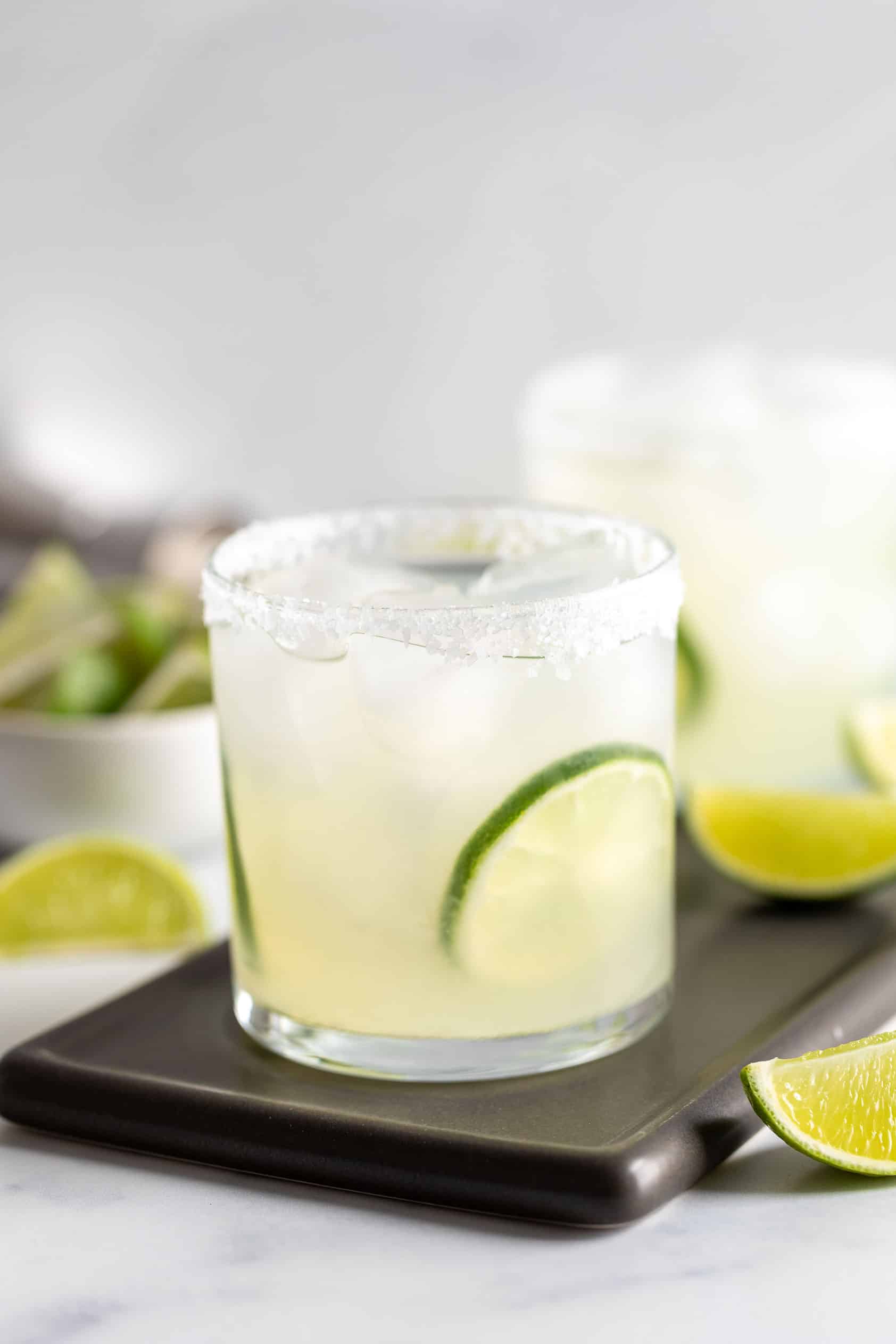 Simple margarita in a glass with lime.