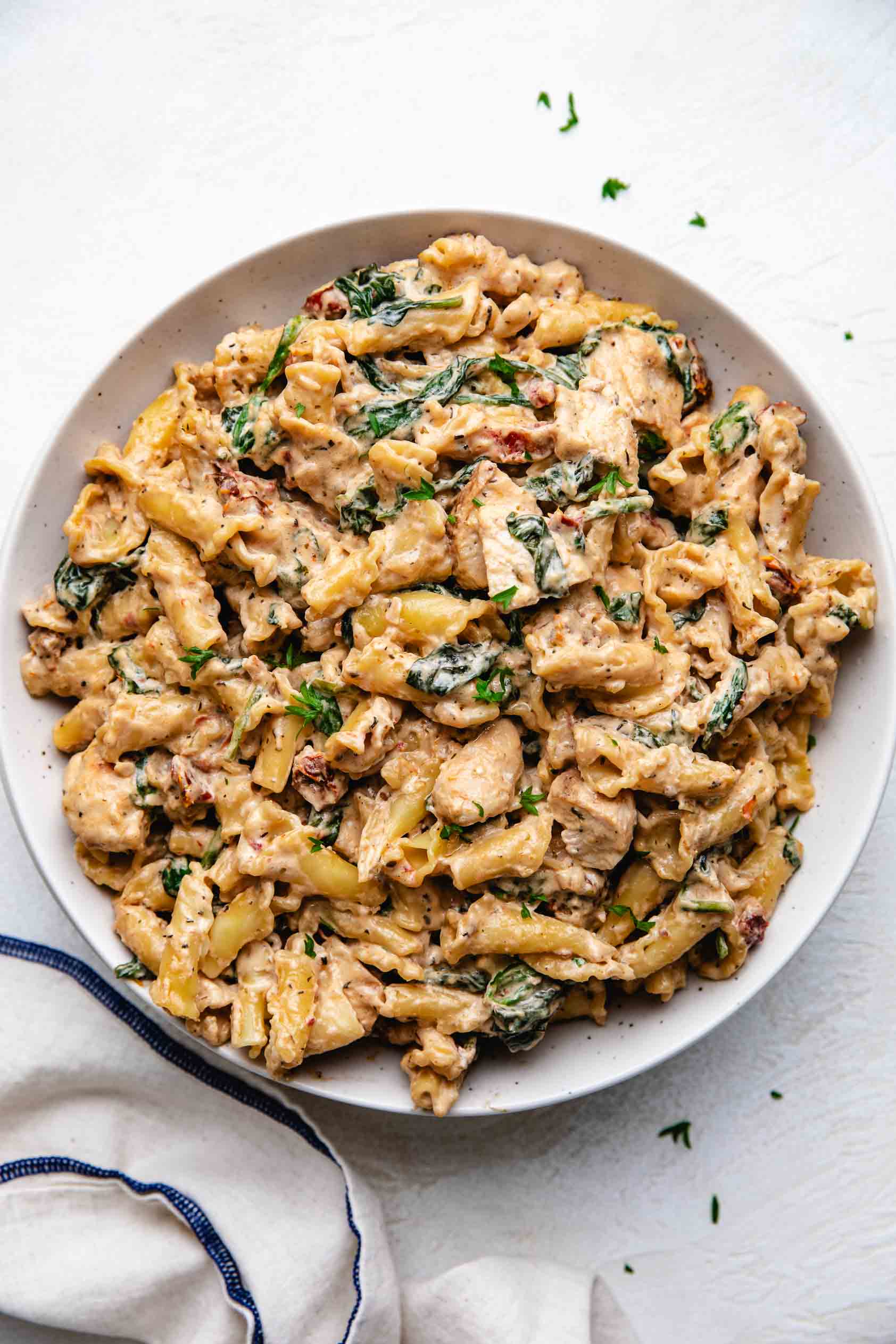 Large bowl of creamy tuscan chicken pasta.