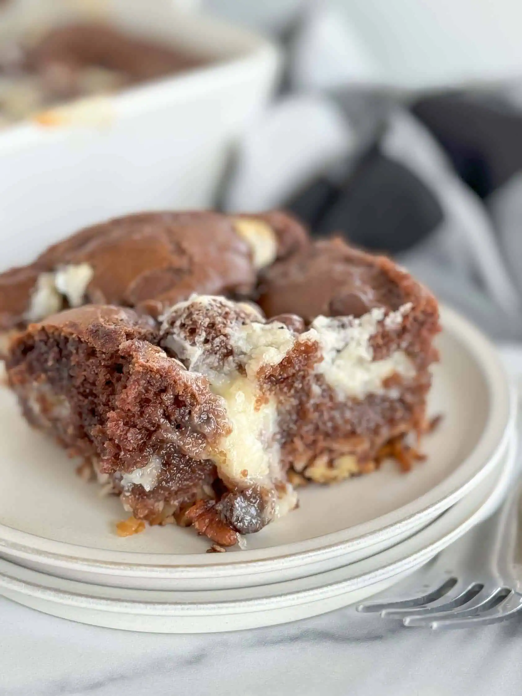 German Chocolate Earthquake Cake Slice of earthquake cake with cream cheese.