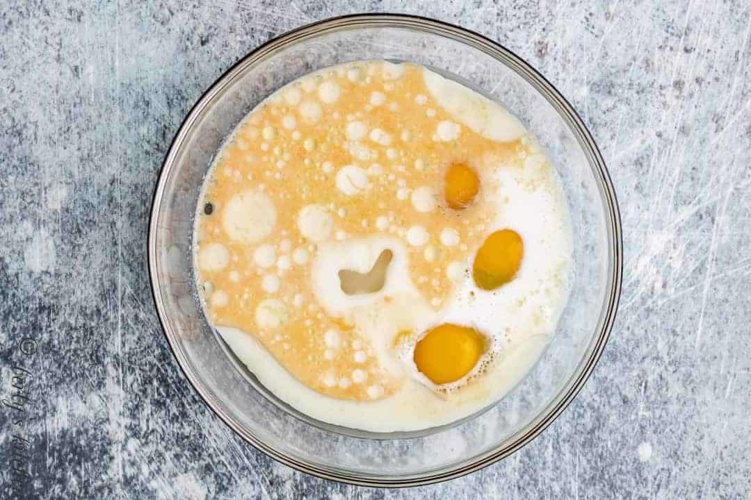 Sugar, eggs, and other ingredients in a separate mixing bowl.