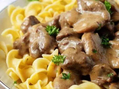 Instant pot beef stroganoff with egg noodles on a plate.