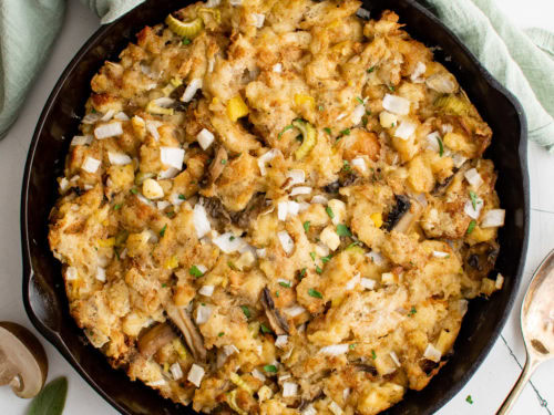 Overhead view of sage stuffing in cast iron.