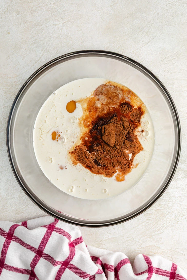 Cinnamon Roll French Toast Bake Bowl of milk, eggs, and spices.