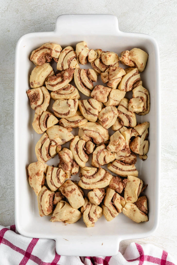 Cut up cinnamon rolls in a pan.