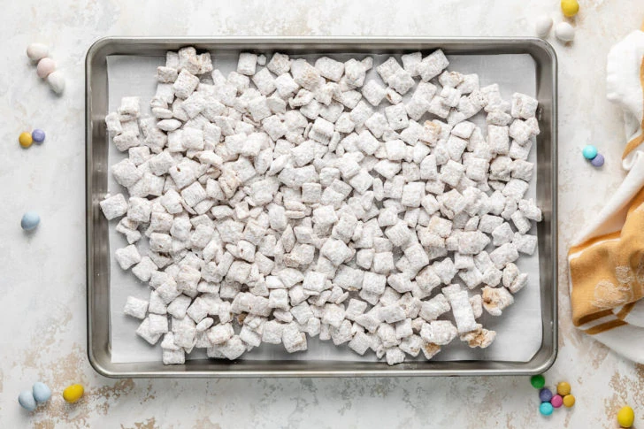 A tray of coated cereal on a baking sheet.