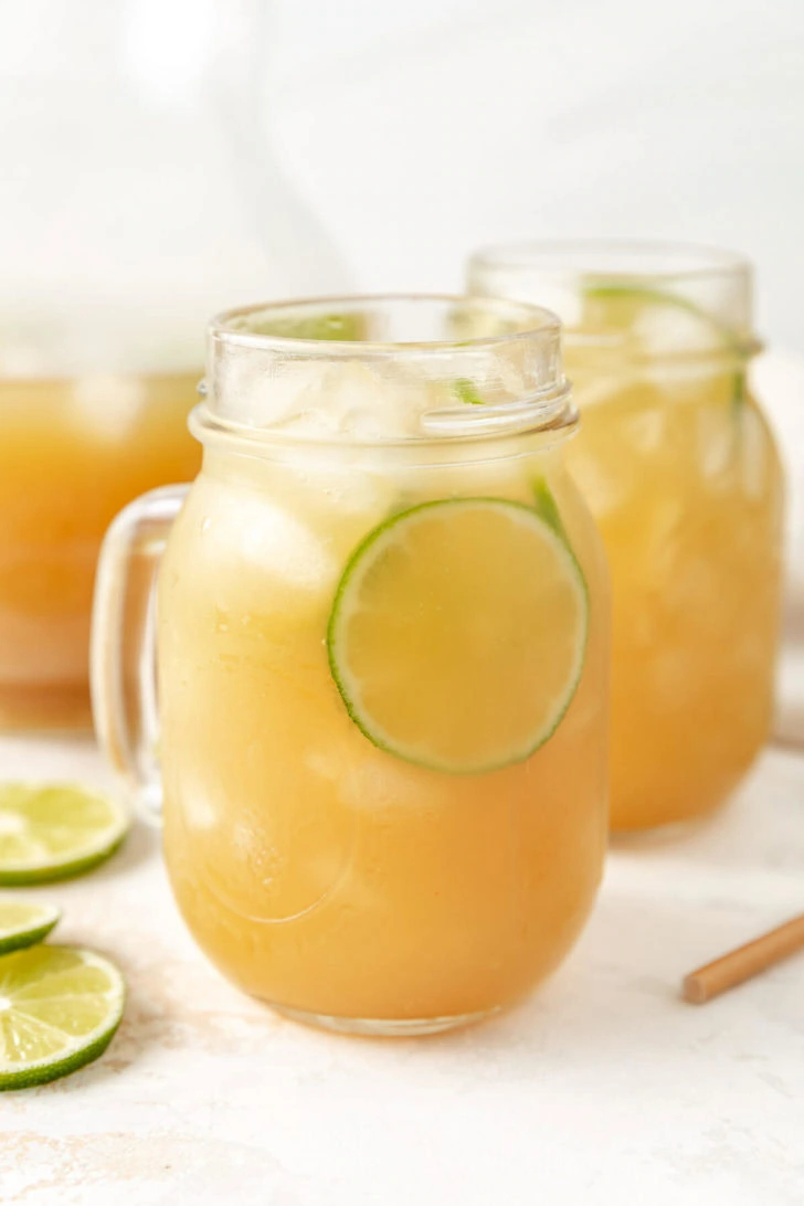 A close up of a drink in a glass jar.