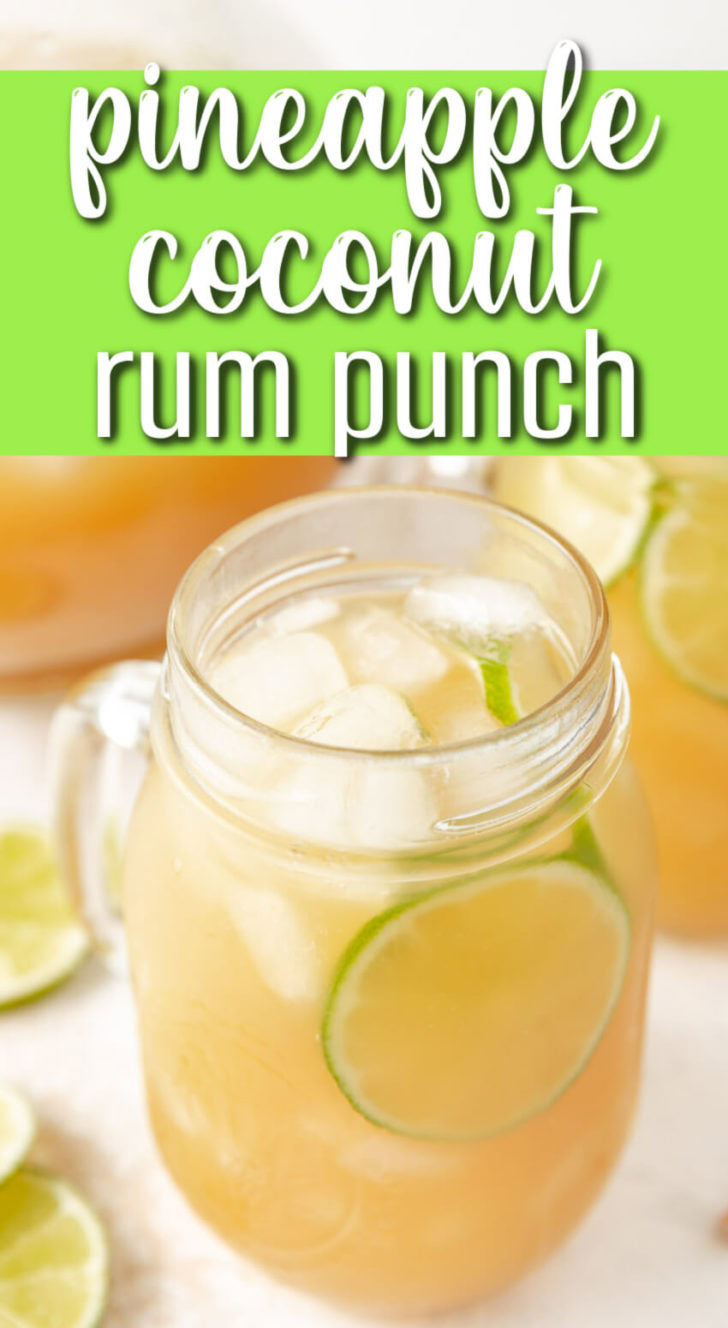 A glass jar with a drink and limes in it.