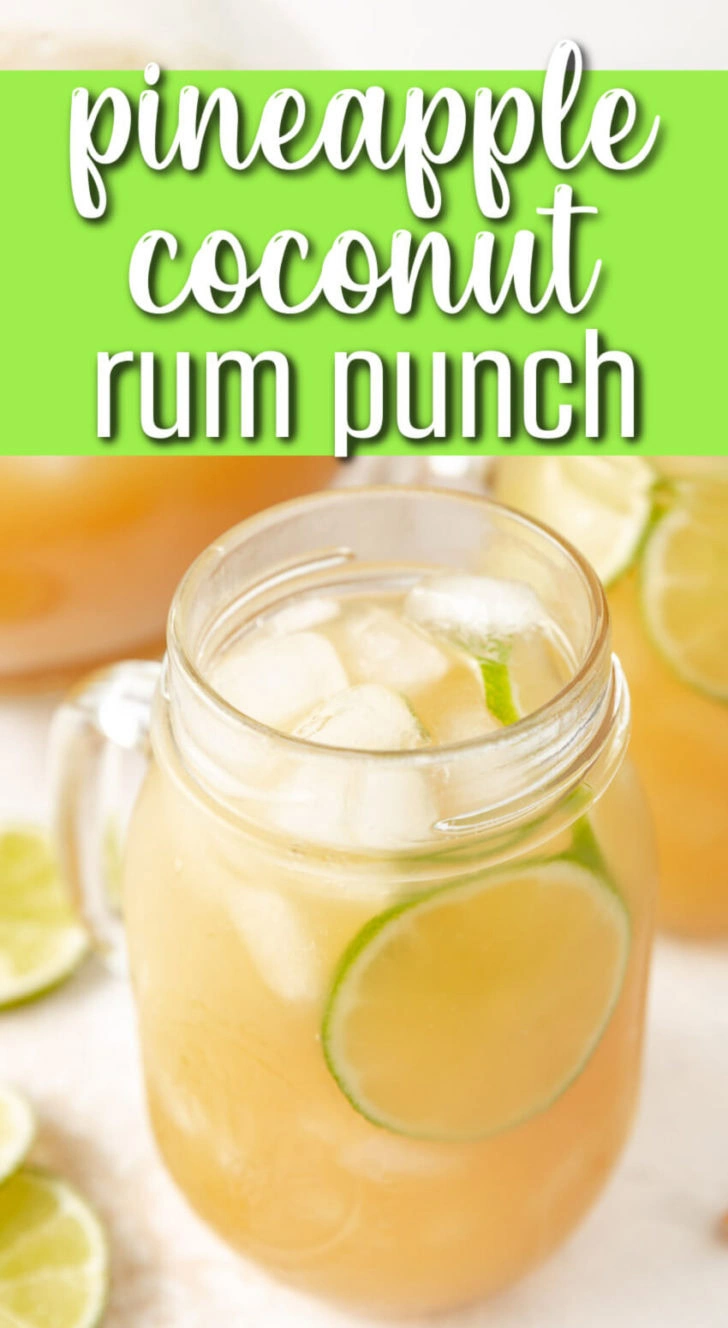 A glass jar with a drink and limes in it.