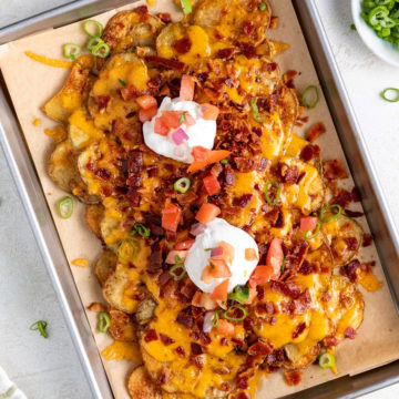 A sheet pan of crispy potato nachos.
