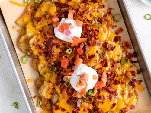 A sheet pan of crispy potato nachos.