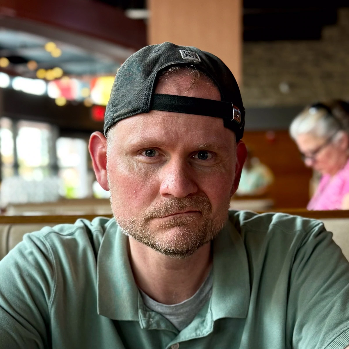 Johnathan vargo in a green shirt in a restaurant.
