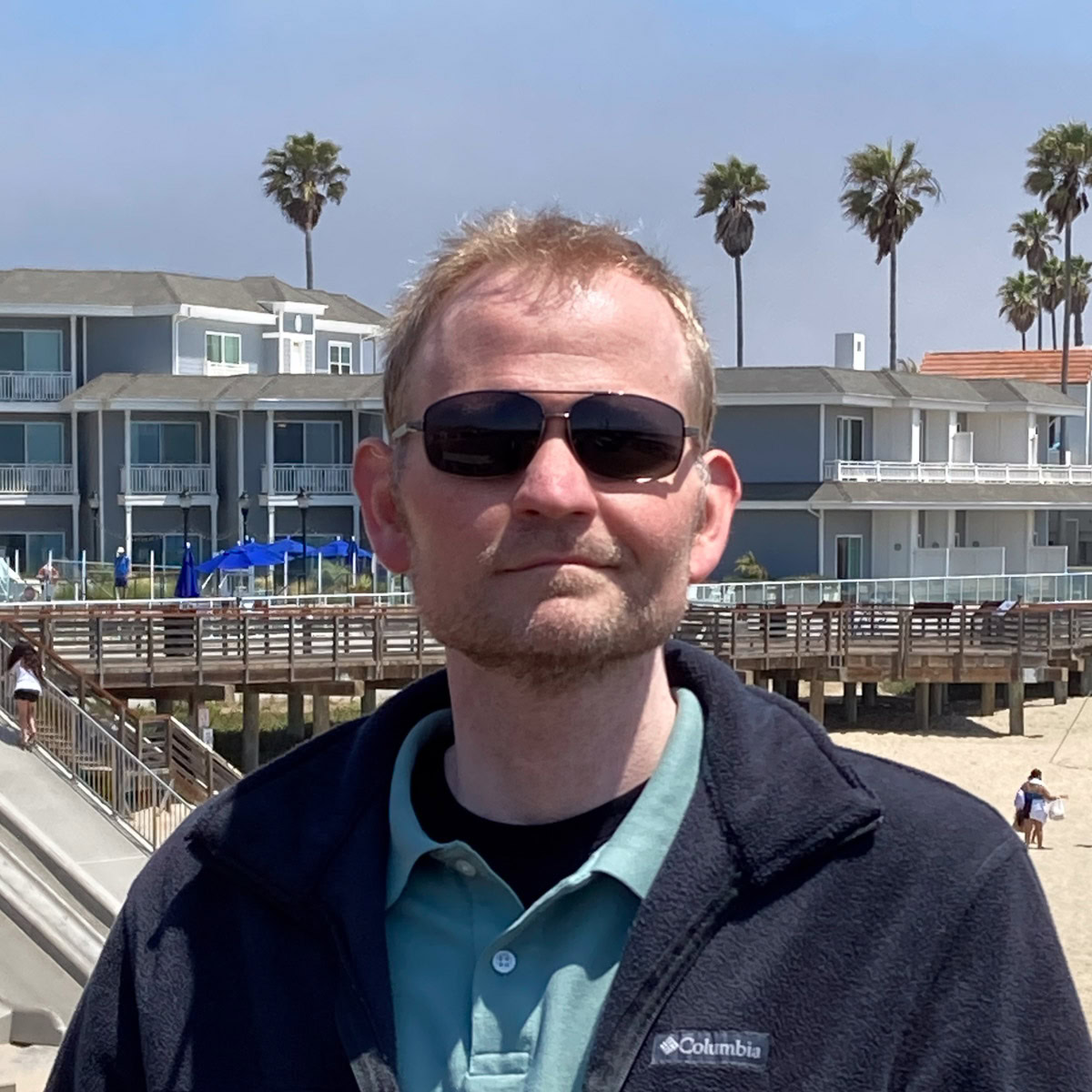 Johnathan vargo in a jacket at the beach.