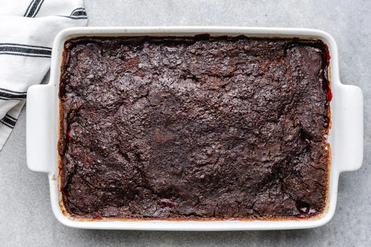 Cherry dump cake in a white pan.