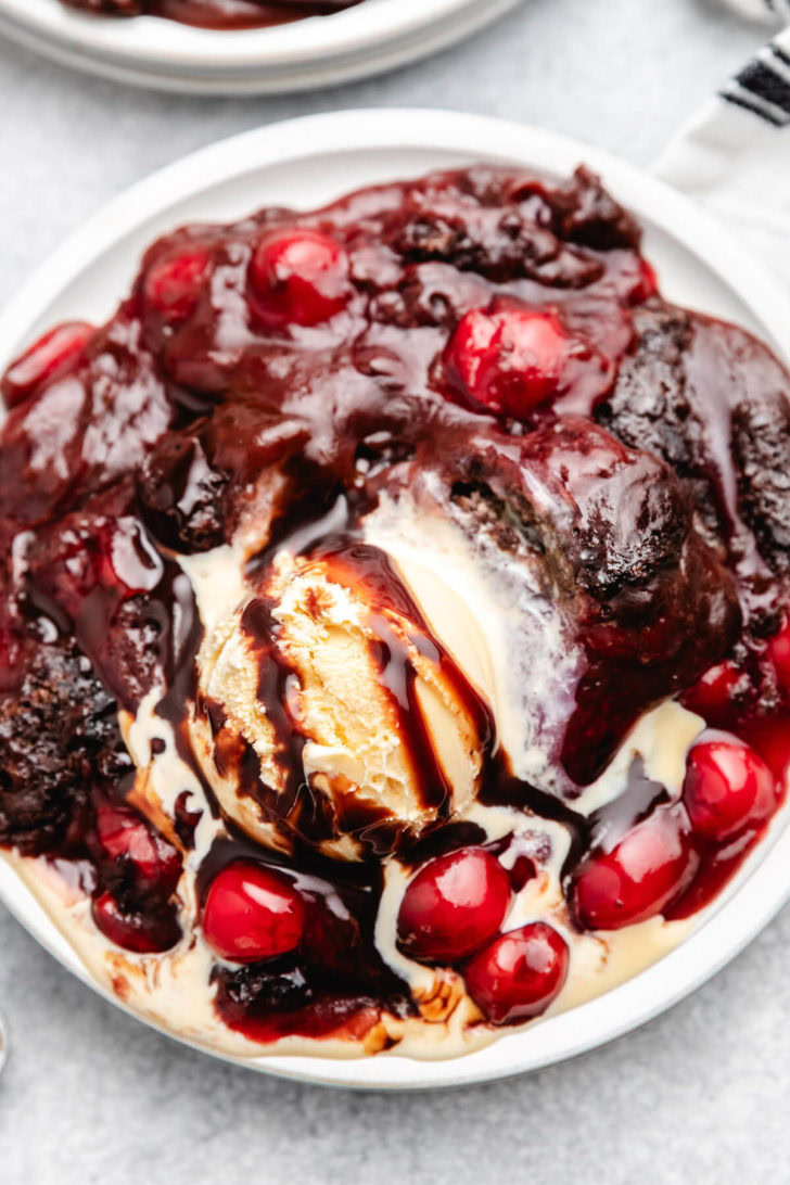 Cherry Cola Dump Cake Overhead view of ice cream melting on chocolate cake.