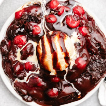 Overhead view of cherry cola dump cake with ice cream.