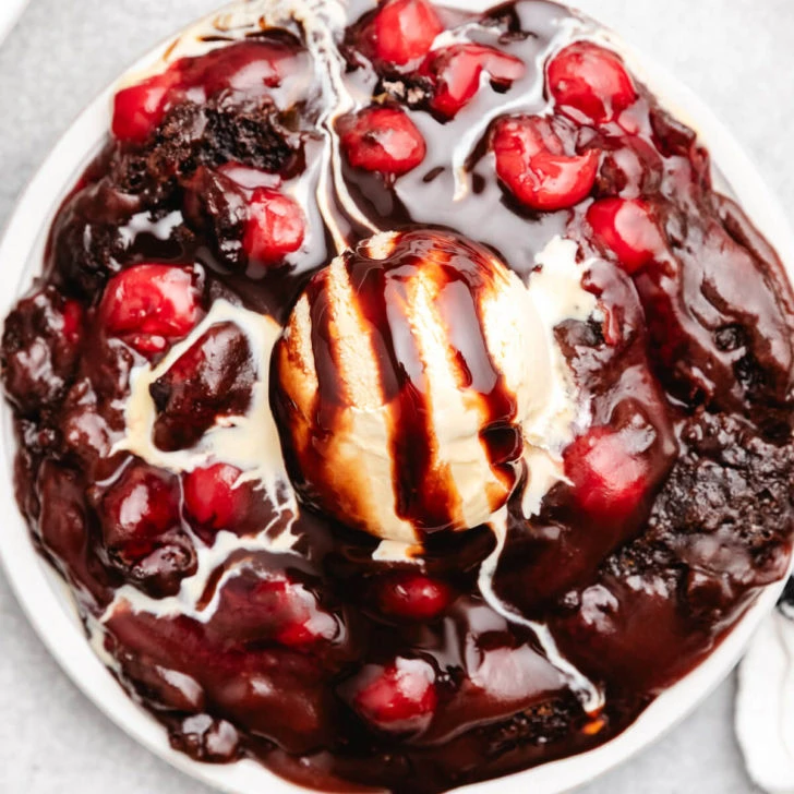 Overhead view of cherry cola dump cake with ice cream.