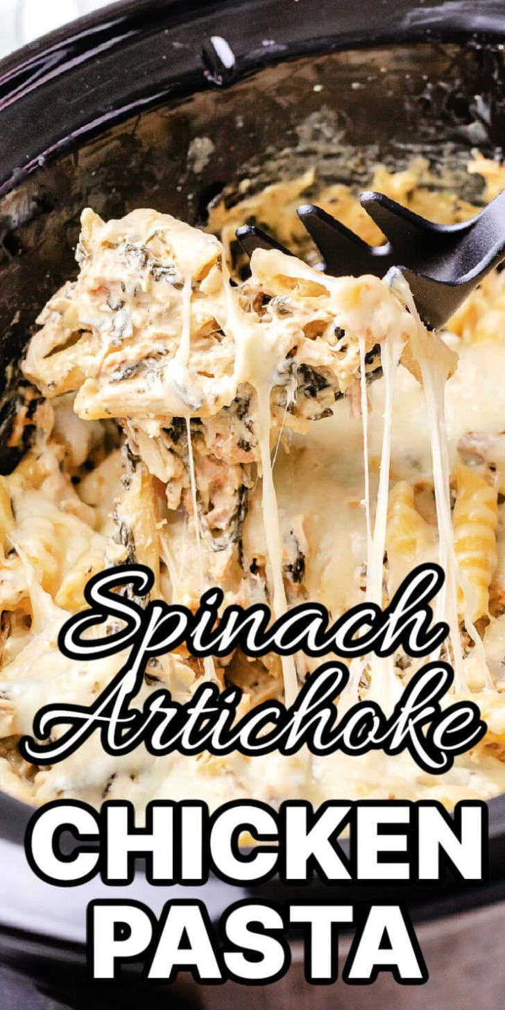 Spoon scooping spinach artichoke chicken pasta from a slow cooker.