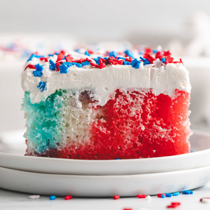 Red, white, and blue jello poke cake on a plate.