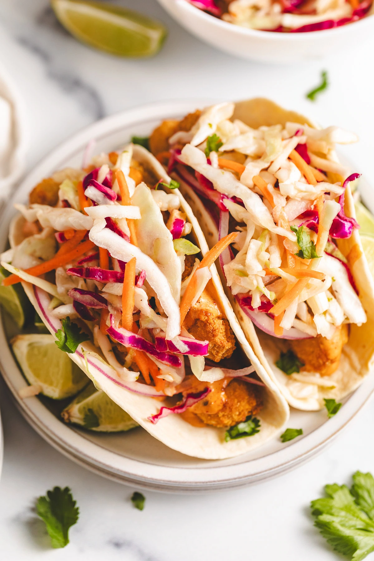 Slaw on top of fish sticks.