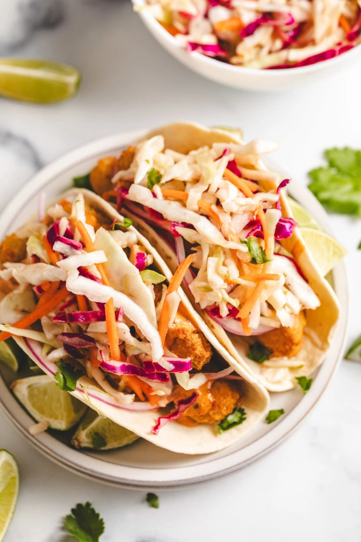 Overhead view of fish tacos with light slaw.